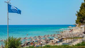 On the beach, white sand, sun-loungers, beach umbrellas