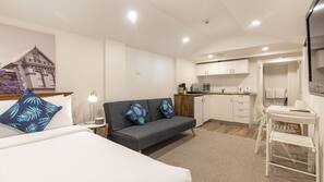 Desk, laptop workspace, blackout drapes, iron/ironing board