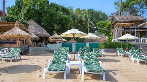 On the beach, sun-loungers, beach umbrellas, beach towels