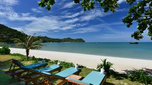 On the beach, sun-loungers, beach umbrellas, beach towels