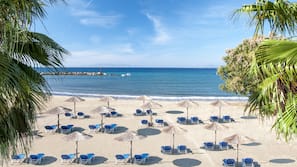 On the beach, sun loungers, beach umbrellas, beach towels