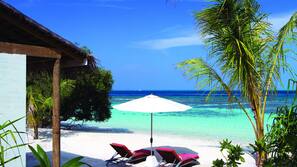 On the beach, white sand, sun loungers, beach umbrellas