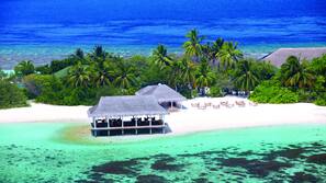 On the beach, white sand, sun loungers, beach umbrellas