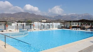 Seasonal outdoor pool, open 7:30 AM to 8:00 AM, pool umbrellas