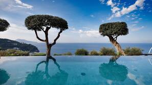 Seasonal outdoor pool, open 9 AM to 7 PM, pool umbrellas, pool loungers