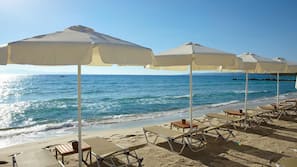 On the beach, sun loungers, beach umbrellas
