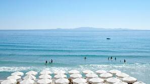 On the beach, sun loungers, beach umbrellas
