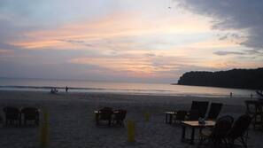 On the beach, white sand, sun-loungers, beach umbrellas