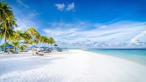 On the beach, white sand, free beach cabanas, sun-loungers