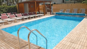 Seasonal outdoor pool, pool umbrellas, pool loungers