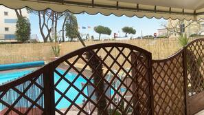 Seasonal outdoor pool, pool umbrellas, pool loungers