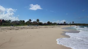 On the beach, white sand, beach umbrellas, beach yoga