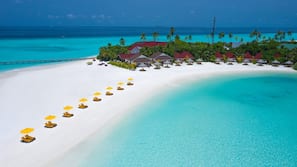 On the beach, white sand, beach umbrellas, beach towels