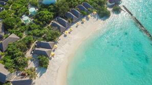 On the beach, white sand, beach umbrellas, beach towels