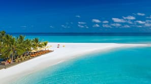 On the beach, white sand, beach umbrellas, beach towels