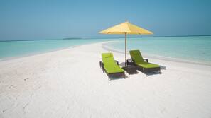 On the beach, white sand, beach umbrellas, beach towels