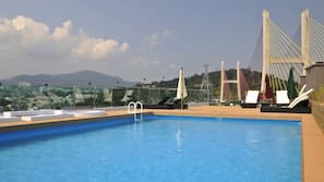 Seasonal outdoor pool, open 1:30 PM to 9:00 PM, pool umbrellas