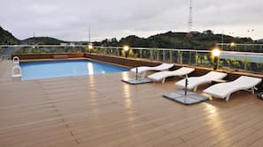 Seasonal outdoor pool, open 1:30 PM to 9:00 PM, pool umbrellas