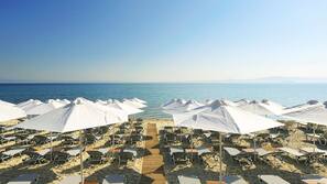 On the beach, sun-loungers, beach umbrellas, beach towels