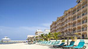 On the beach, white sand, sun-loungers, beach umbrellas