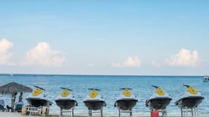 On the beach, white sand, sun-loungers, beach umbrellas