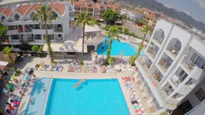 2 outdoor pools, open 8:00 AM to 8:00 PM, pool umbrellas, pool loungers