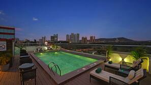 Outdoor pool, open 7 AM to 8 PM, pool loungers