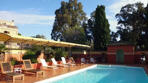Seasonal outdoor pool, pool loungers