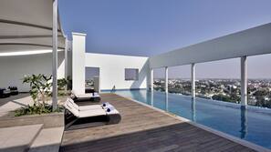 Outdoor pool, open 7 AM to 8 PM, pool loungers