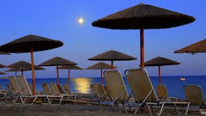 On the beach, sun-loungers, beach umbrellas, beach towels