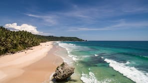 On the beach, white sand, beach towels, beach massages