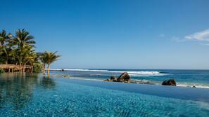 Outdoor pool, an infinity pool, pool umbrellas, pool loungers