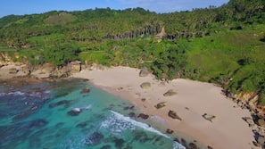 On the beach, white sand, beach towels, beach massages