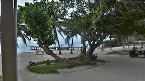 On the beach, white sand, sun loungers, beach towels