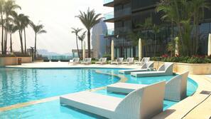 Outdoor pool, pool umbrellas, lifeguards on site