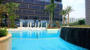 Outdoor pool, pool umbrellas, lifeguards on site