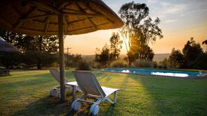 Outdoor pool, a waterfall pool, pool umbrellas, sun loungers