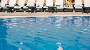Outdoor pool, open 9 AM to 8 PM, pool loungers