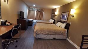 Premium bedding, desk, laptop workspace, blackout drapes