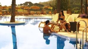 Indoor pool, outdoor pool, pool umbrellas, pool loungers