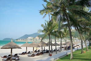 Private beach, white sand, sun loungers, beach umbrellas