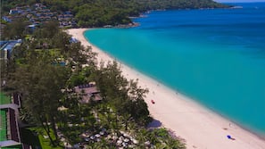 On the beach, white sand, sun-loungers, beach umbrellas
