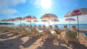 On the beach, sun-loungers, beach umbrellas, beach towels
