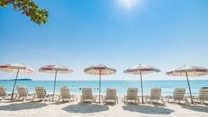 On the beach, sun-loungers, beach umbrellas, beach towels