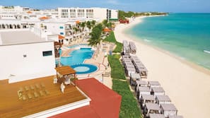 On the beach, white sand, beach cabanas, sun-loungers
