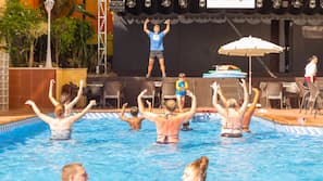 Una piscina al aire libre de temporada, sombrillas, tumbonas