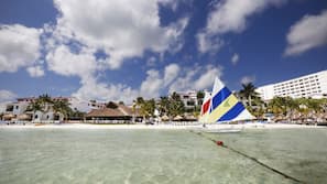 On the beach, white sand, sun loungers, beach umbrellas
