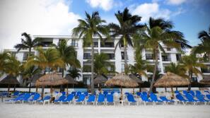 On the beach, white sand, sun loungers, beach umbrellas