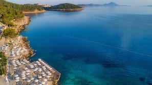 Sulla spiaggia, sabbia bianca, lettini da mare, ombrelloni