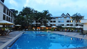 nairobi hotel jacaranda pool loungers umbrellas sun outdoor